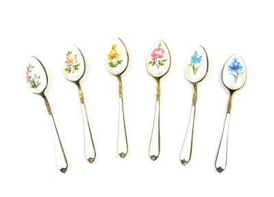 A set of six silver gilt and enamel coffee spoons, painted with flowers against a white guilloche and enamel ground, cased, Elkington & Company, Birmingham 1962, 2.23oz.