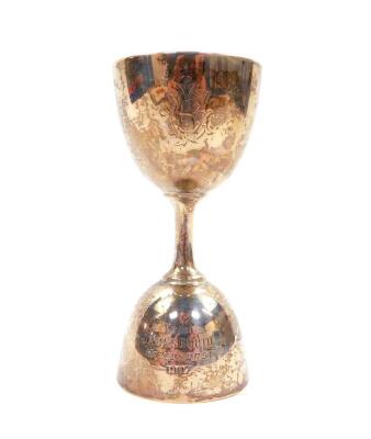 An Edward VII silver double egg cup, of single handled double sized form, presentation engraved, Sheffield 1905, 2.78oz.