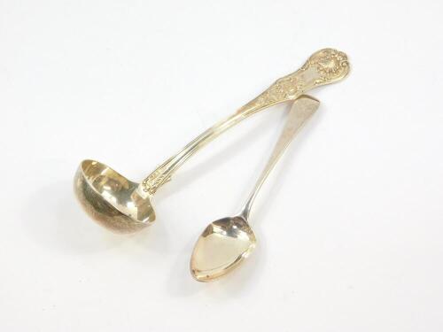 A Victorian Scottish silver cream ladle decorated in the Kings pattern, possibly Alexander Coghill, Glasgow 1846., together with a George III silver teaspoon, monogram engraved, 2.09oz.