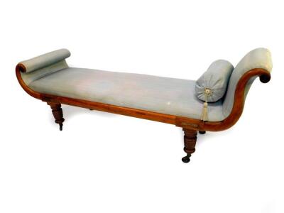 A late Regency mahogany and brass inlaid chaise longue, upholstered in turquoise silk fabric, raised on turned legs, on castors, 202cm wide.