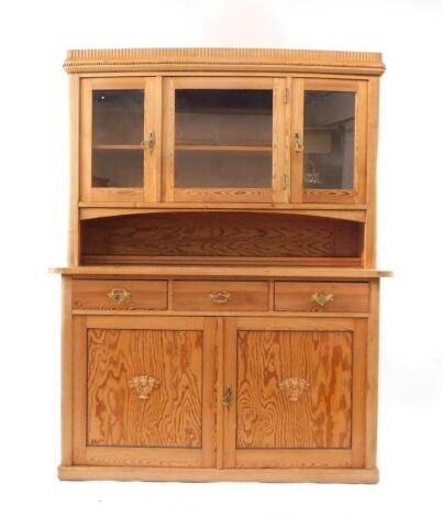 A Victorian stripped pitch and plain pine dresser, with beaded and glazed upper section, three drawer over two cupboard door base with applied mouldings, 152cm wide.