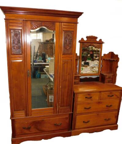 A Victorian carved walnut bedroom pair, comprising single wardrobe, with mirrored door and drawer base, 110cm wide, and dressing chest. (2)