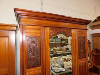 A Victorian carved walnut bedroom pair, comprising single wardrobe, with mirrored door and drawer base, 110cm wide, and dressing chest. (2) - 3