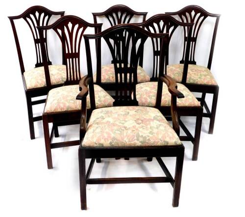 A set of six George III mahogany dining chairs, including carver, with Hepplewhite style pierced vase splats, drop in seats, H frame stretchers and moulded legs.