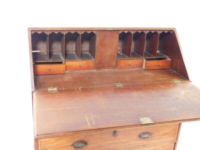 A George III mahogany bureau, with fall flap resting on lopers enclosing fitted interior, over two short and three long graduated drawers, with line inlay and oval back plate replacement handles, on bracket feet, 109cm wide. - 2