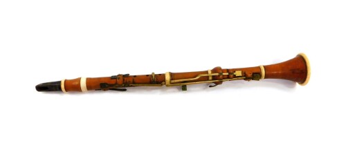 A 19thC boxwood and ivory bound clarinet by H Wrede, London, with brass keys, 58.5cm wide.