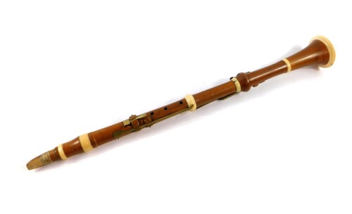 A 19thC boxwood and ivory bound clarinet by Aston & Company, London, with brass keys, 66cm wide.