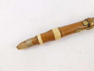 A 19thC boxwood and ivory bound clarinet by Aston & Company, London, with brass keys, 66cm wide. - 2