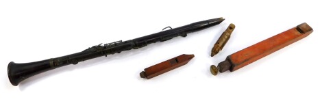 A 19thC rosewood clarinet, 67.5cm long., a rustic whistle carved with a head of a bird, and two further woodwind instruments. (4)