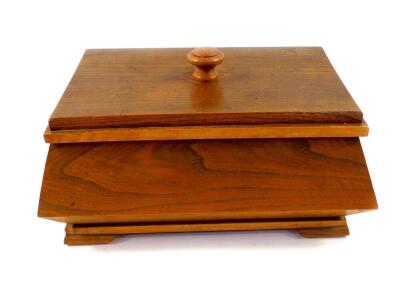 An Art Deco oak sewing box, of casket form, the lid opening to reveal an interior with single compartmented tray, raised on bracket feet, 60.5cm high, 31cm wide, 20.5cm deep.