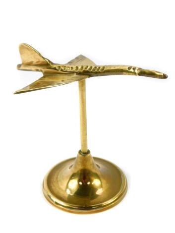 A brass desk stand modelled as Concorde, 16.5cm wide.