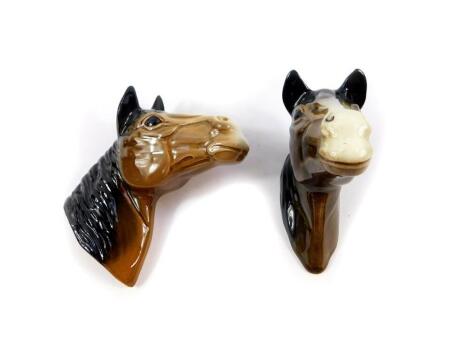 A pair of late 20thC pottery horse's head wall plaques, 14cm high.