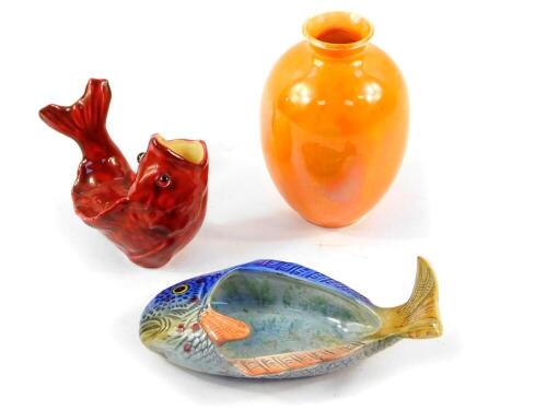 A Moore Bros red glazed pottery figure of a fish, with glass eyes, 9.5cm wide., Beswick fish dish, No 1304., and a Royal Doulton orange lustre vase, 10cm high. (3)