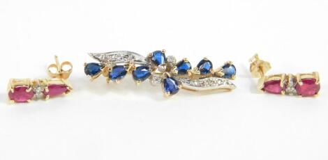 A sapphire and diamond floral spray brooch, set in yellow metal, stamped 9ct, 2.3g., together with a pair of ruby and diamond drop earrings, set in yellow metal, stamped 10k, 1.2g. (2)