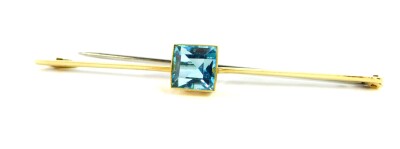 A 15ct gold and aquamarine bar brooch, the square cut aquamarine approx 3 1/2ct, 5.2g.