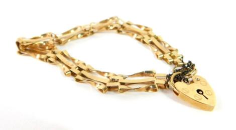 A 9ct gold three bar gate bracelet, on a heart shaped padlock clasp, with safety chain as fitted, 6.9g.