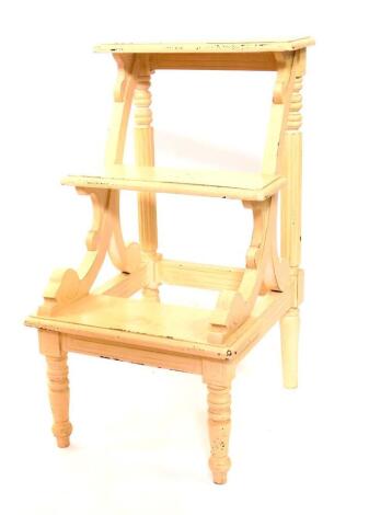 A set of Victorian style cream painted library steps, of three step form, with scrolling supports, raised on turned legs, 80.5cm high, 45cm wide, 50cm deep.