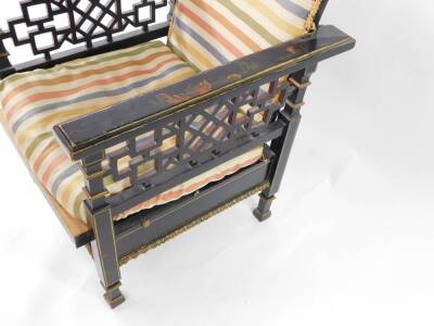 An early 20thC Japanned black lacquer and chinoiserie decorated reclining armchair, with fret work sides and carved cresting rail, 60cm over arms. - 2