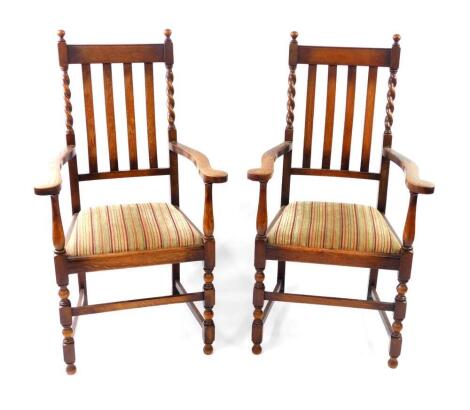 A pair of 1920's barleytwist oak carver chairs, with drop-in seats.