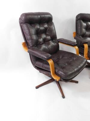 A pair of modern cantilever swivel office chairs, with brown leather effect upholstery and faux rosewood metal swivel base, labelled Montering; Denna Sida UPP. - 2