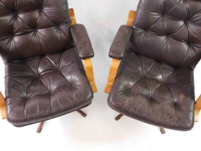 A pair of modern cantilever swivel office chairs, with brown leather effect upholstery and faux rosewood metal swivel base, labelled Montering; Denna Sida UPP. - 3