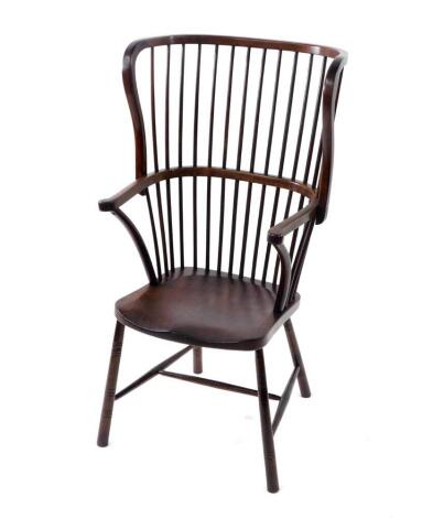 A Victorian stained beech wing high back Windsor chair, by Druce & Co, London, with crook arms, and spindle uprights, H frame turned stretcher, 54cm over arms.