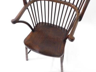 A Victorian stained beech wing high back Windsor chair, by Druce & Co, London, with crook arms, and spindle uprights, H frame turned stretcher, 54cm over arms. - 2