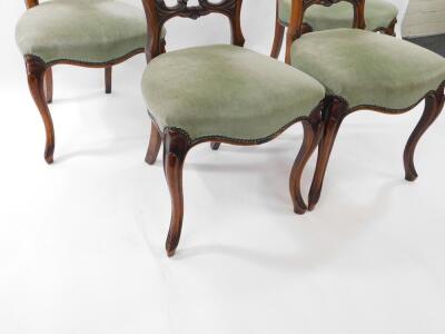 A set of four Victorian walnut carved balloon back dining chairs, with shell carved rails, studied seats and cabriole legs. - 3