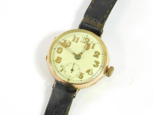 A 1930's 9ct gold wristwatch, circular cased, cream dial bearing Arabic numerals, subsidiary seconds dial, on a leather strap, 26.3g all in.