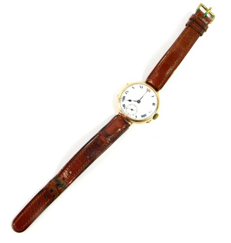 A 9ct gold wristwatch, circa 1915, circular cased, white enamel dial bearing Roman numerals, subsidiary seconds dial, on a leather strap, 28.4g all in.