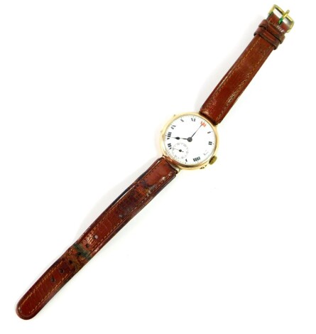 A 9ct gold wristwatch, circa 1915, circular cased, white enamel dial bearing Roman numerals, subsidiary seconds dial, on a leather strap, 28.4g all in.