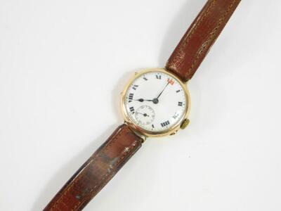 A 9ct gold wristwatch, circa 1915, circular cased, white enamel dial bearing Roman numerals, subsidiary seconds dial, on a leather strap, 28.4g all in. - 2