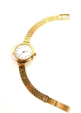 A lady's early 20thC 9ct gold circular cased wristwatch, white enamel dial bearing Arabic numerals, Swiss movement, on a 9ct gold strap, 34.0g all in.