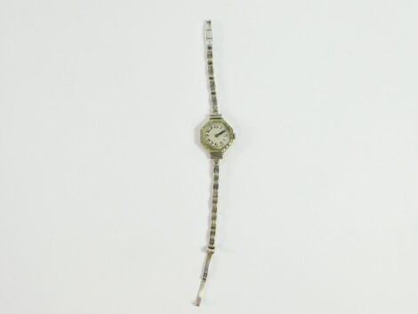 A lady's 18ct white gold and diamond cocktail watch, circular white dial bearing Arabic numerals, octagonal bezel set with diamonds, Swiss 15 jeweled movement, on a 9ct gold channelled link strap, on a snap clasp, 17.5g all in.