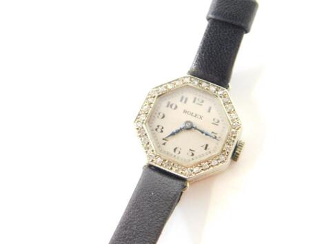 A Rolex lady's 18ct white gold and diamond set cocktail wristwatch, silvered octagonal dial bearing Arabic numerals, the bezel set with diamonds, Rolex Prima fifteen jeweled movement, on a leather strap, approx 0.5cts.