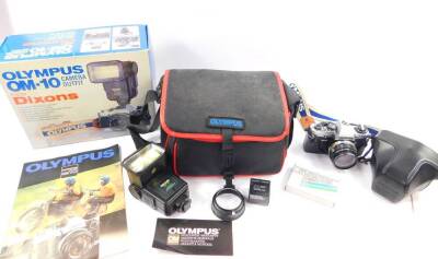 An Olympus OM10 camera, with a Zuiko Auto-S 50mm 1:1, 8 lens. cased, an Olympus Miranda 650 OM flash, wide angled diffuser and coloured filters, leaflets, etc, in an Olympus holdall, boxed.