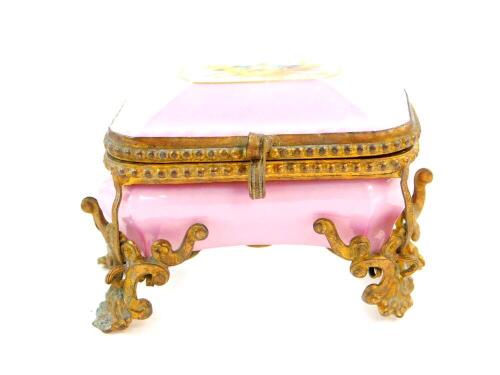 A Paris late 19thC porcelain miniature casket, with foiled brass mounts, reserve painted to the lid with a pair of swallows and a nest, against a pink ground, printed marks, 8cm wide.