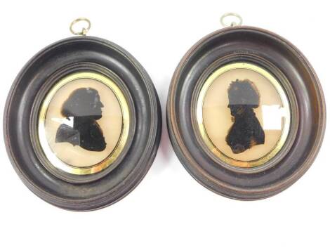 A pair of Georgian late 18thC silhouette portraits of a gentleman and lady, oval framed, 9.5cm high, 8cm wide.