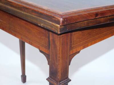 An Edwardian Sheraton Revival card table, with shaped rectangular fold over top with cross banding, on square taper legs with spade feet, 85cm wide. - 5