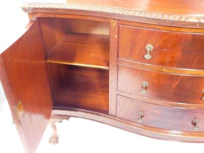 An early 20thC mahogany serpentine sideboard, with shaped splash back, gadrooned top, three central doors enclosed by concave doors, blind fret canted sides, and cabriole legs with ball and claw feet, 156cm wide. - 2