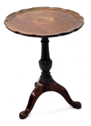 A Georgian mahogany tripod table, with circular moulded piecrust tilt top, baluster stem and three legs with pad feet, 50cm diameter.