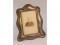 A late Victorian silver photograph frame of shaped rectangular design with