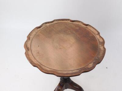 A Georgian mahogany tripod table, with circular moulded piecrust tilt top, baluster stem and three legs with pad feet, 50cm diameter. - 2