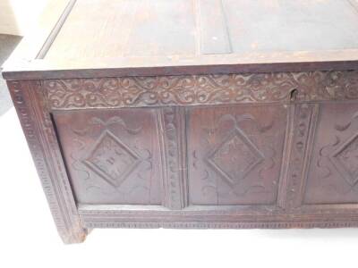 A 17thC oak coffer, with three panel top, Arabesque carved frieze, four lozenge carved panels to the front, raised on stiles, 68cm high, 147cm wide, 59cm deep. - 2