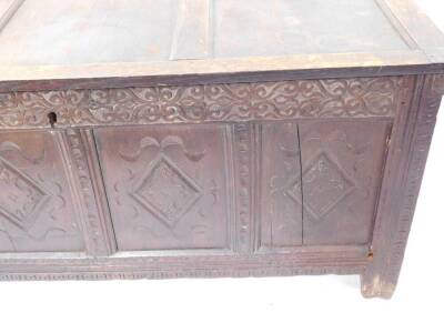 A 17thC oak coffer, with three panel top, Arabesque carved frieze, four lozenge carved panels to the front, raised on stiles, 68cm high, 147cm wide, 59cm deep. - 3