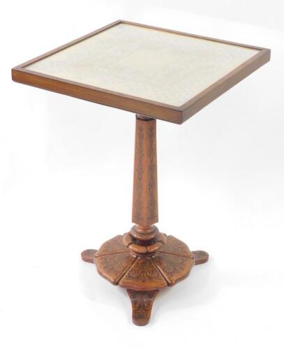 A Victorian occasional table, with lace work and glazed tilt top, on a column and shaped base with rosewood marquetry on walnut, and stained pine, 62cm high, 44cm square.