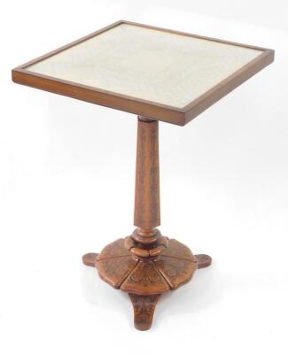 A Victorian occasional table, with lace work and glazed tilt top, on a column and shaped base with rosewood marquetry on walnut, and stained pine, 62cm high, 44cm square.