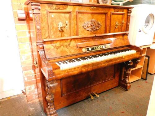 A 19thC German figured and burr walnut cased upright piano by F Weber of Berlin, the case having blind fret and applied moulded decoration, cast brass side handles, the interior revealing a brass over wood overstrung mechanism, and label VNWIEN 1875 C Gol