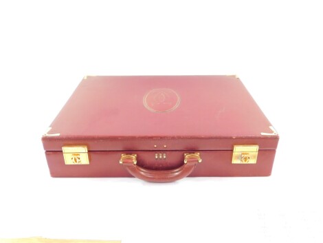 A Le Must De Cartier red leather briefcase, with brass fittings and mounts, Rd 1975, 43cm wide.