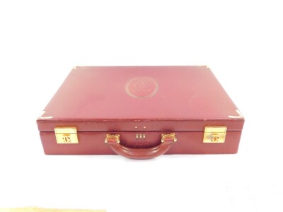 A Le Must De Cartier red leather briefcase, with brass fittings and mounts, Rd 1975, 43cm wide.